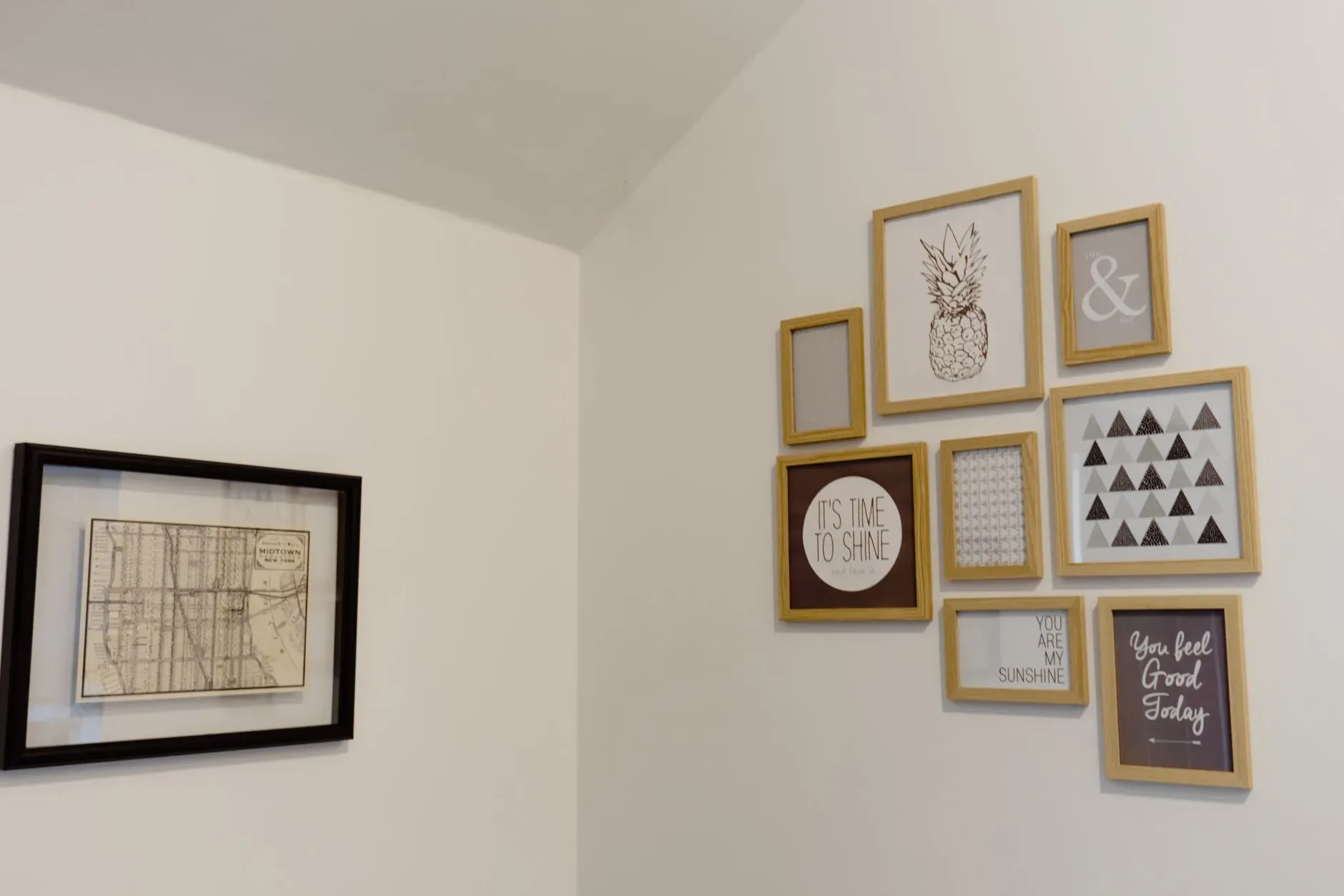 15 High-End Living Room Ideas for Small Spaces A chic arrangement of picture frames on a white wall adds a modern touch to your space.