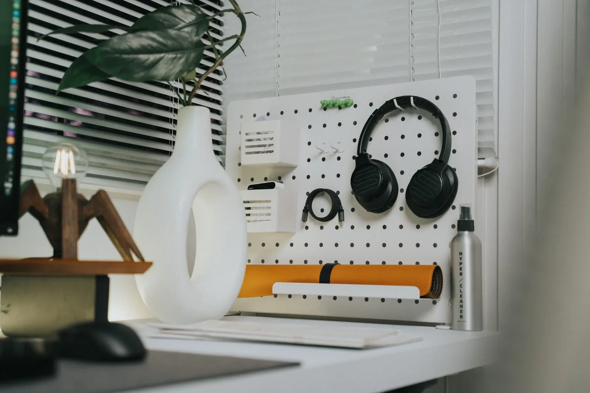 12 Wall Decor Ideas That Turn Every Blank Wall Into Something Beautiful A contemporary workspace featuring a pegboard with headphones and stylish decor.