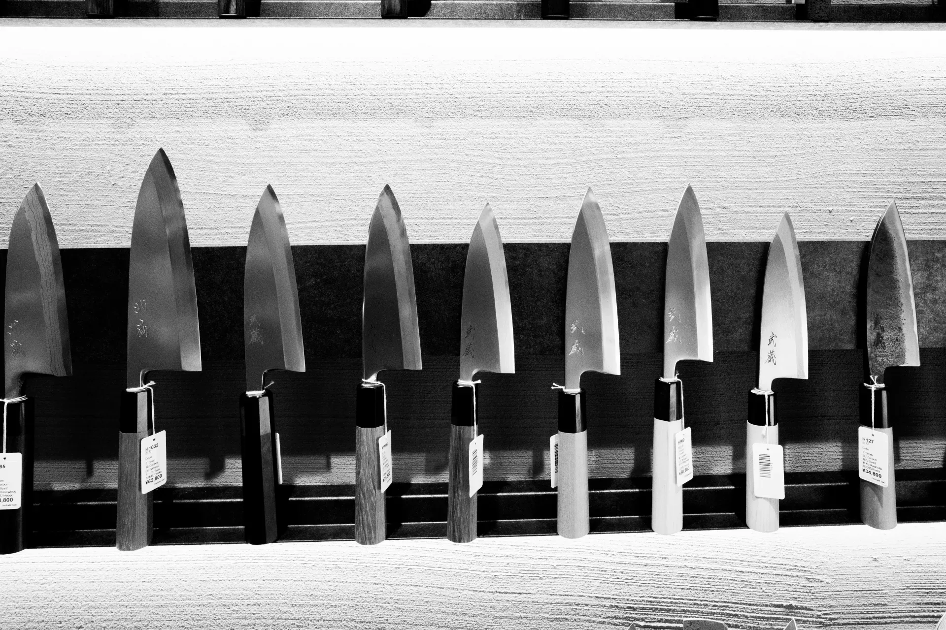 18 Cozy Kitchen Decor Ideas for a Warm Home A row of sharp kitchen knives displayed on a rack.