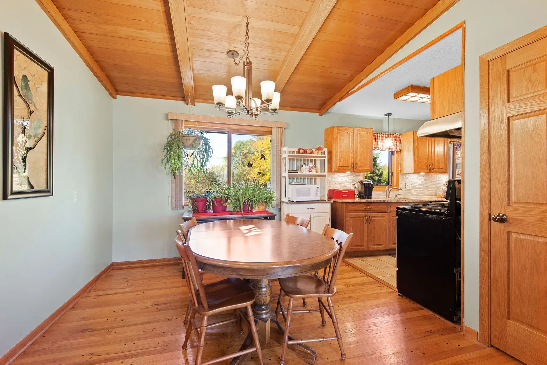 15 Wood Kitchen Ideas That Bring Warmth and Character to Any Home A warm dining room with wooden furniture and natural light offers a cozy atmosphere.