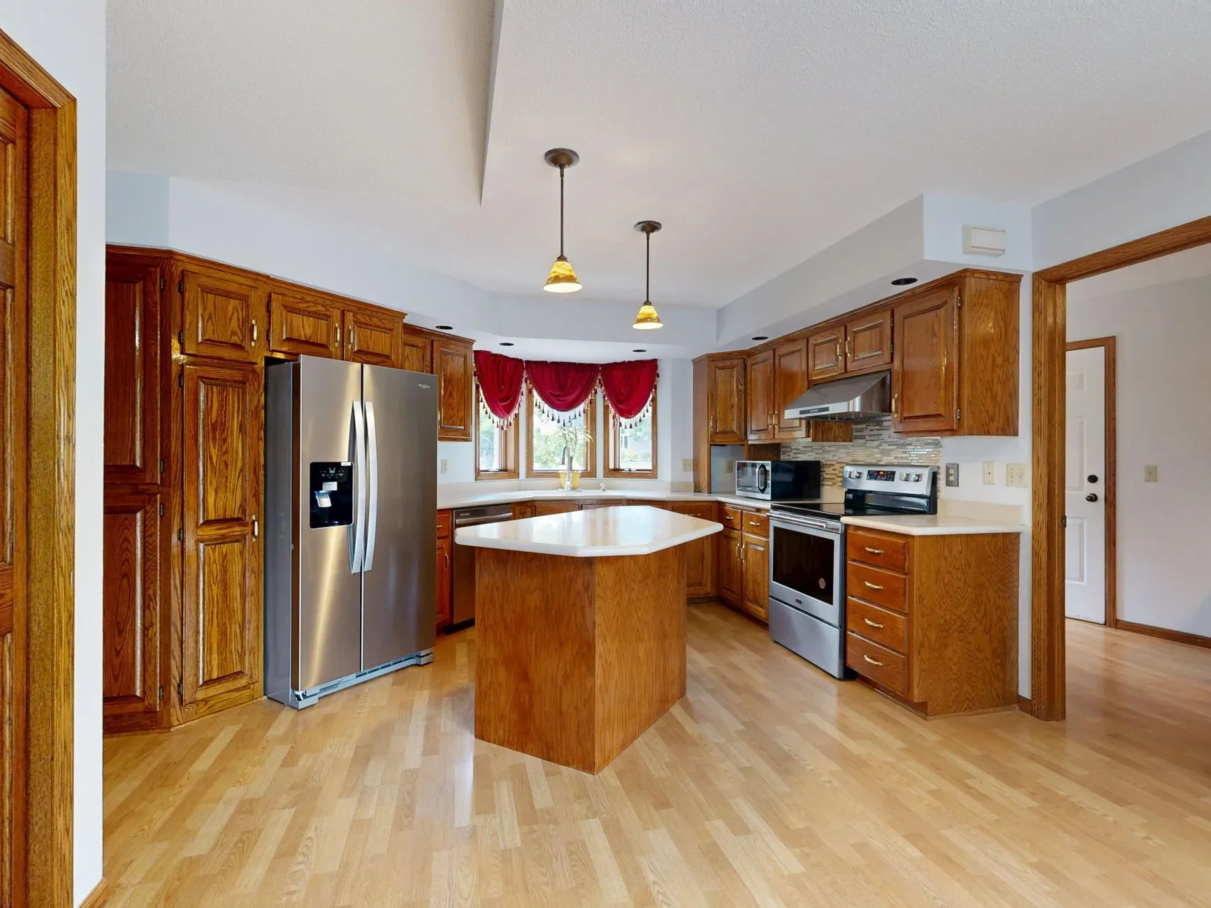 15 Wood Kitchen Ideas That Bring Warmth and Character to Any Home Beautiful kitchen with wooden cabinets, center island, and stainless steel appliances.