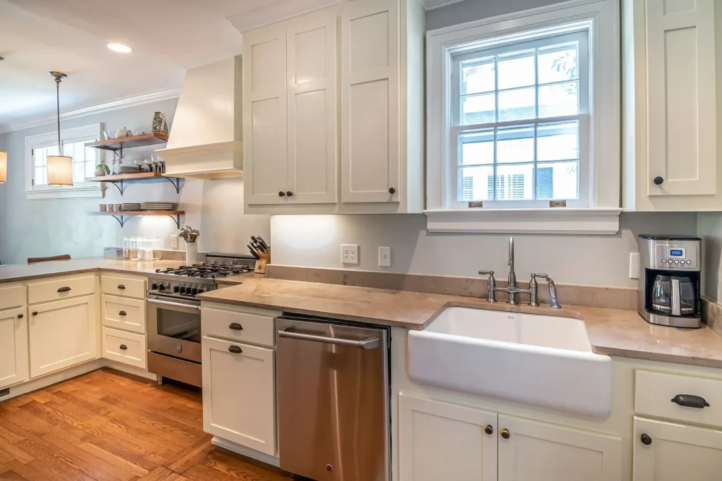 20 Cozy Kitchen Ideas That Make Cooking Feel Like the Best Part of Your Day Bright kitchen with wooden floors and modern white cabinetry.