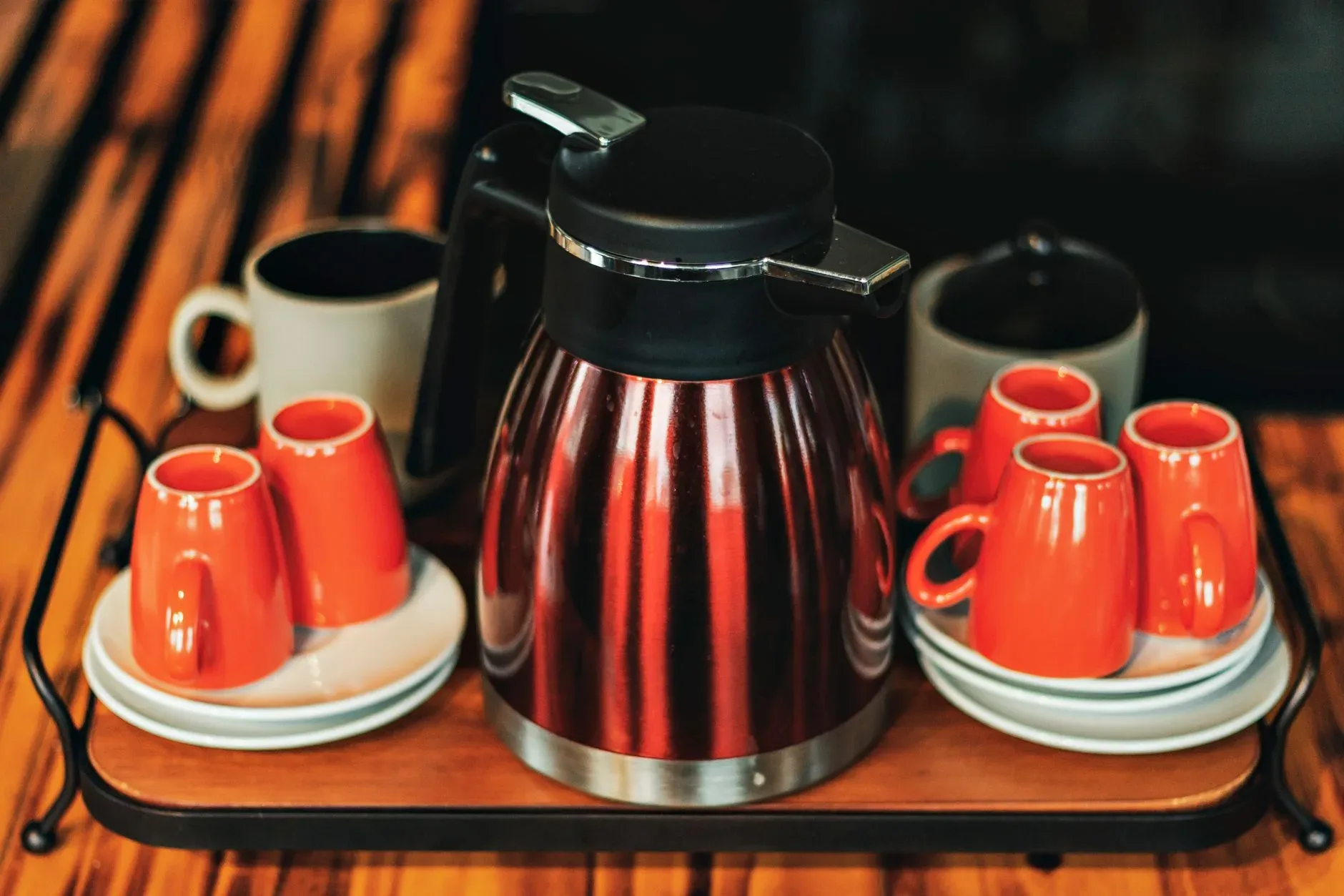 18 Cozy Kitchen Decor Ideas for a Warm Home Close-up of a stylish coffee set with red cups and kettle on a wooden tray, perfect for morning routines.