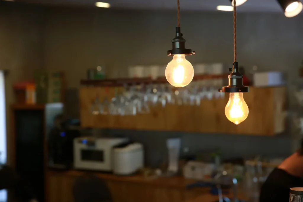 20 Cozy Kitchen Ideas That Make Cooking Feel Like the Best Part of Your Day Close-up of glowing light bulbs hanging in a cozy indoor setting with warm ambiance.