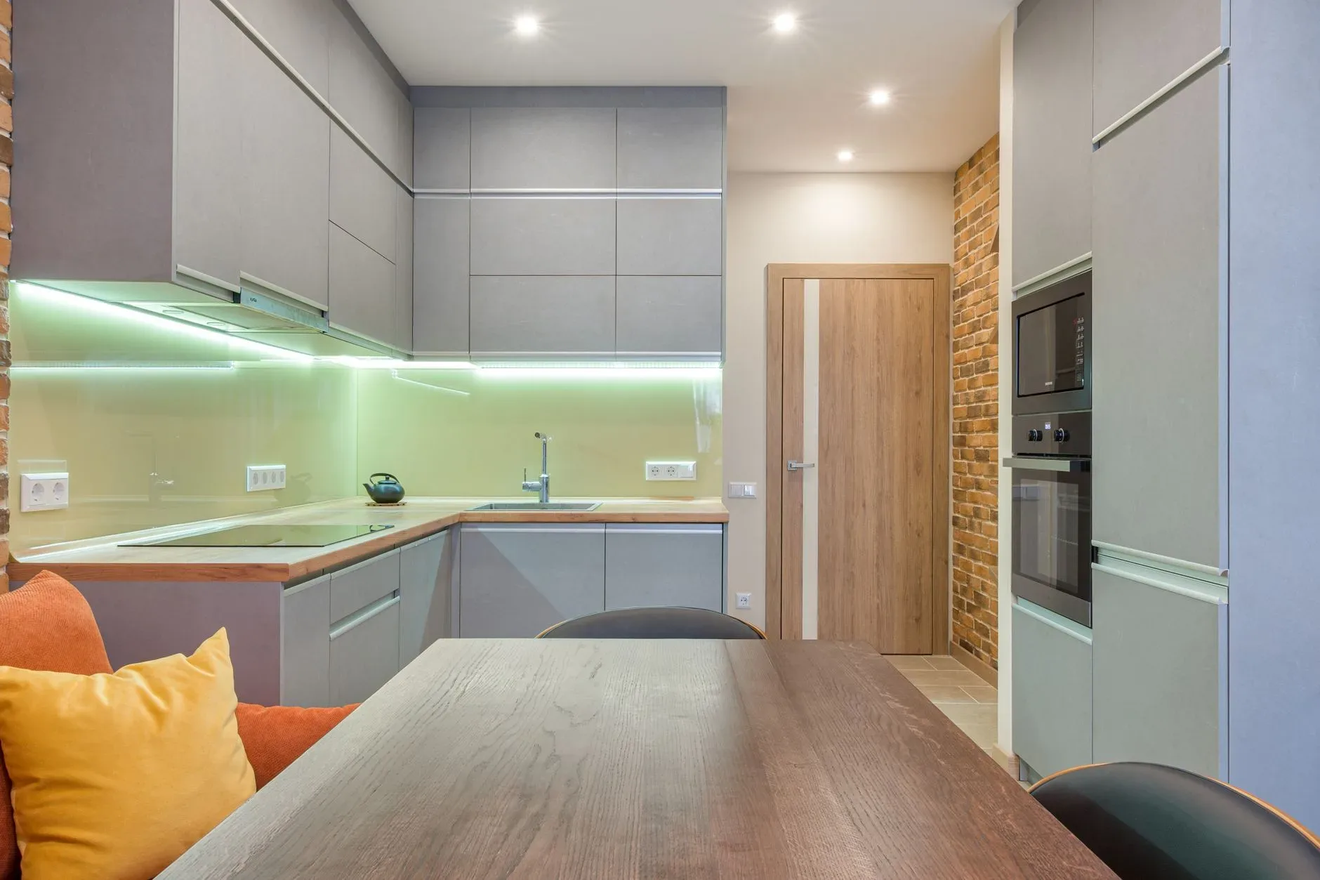 20 Cozy Kitchen Ideas That Make Cooking Feel Like the Best Part of Your Day Contemporary kitchen design with modern lighting and brick accent wall.