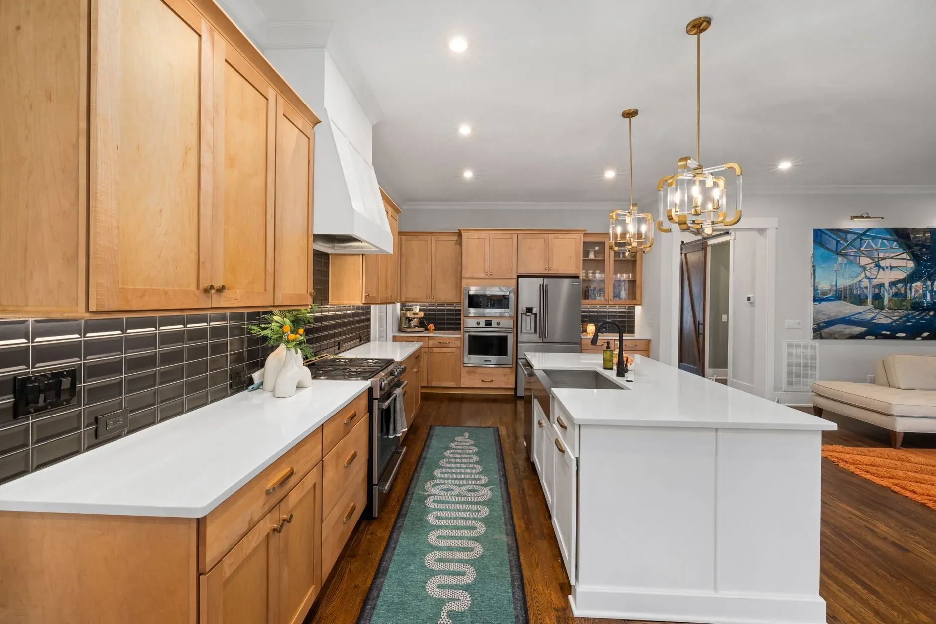 12 Green Kitchen Ideas That Feel Fresh and Modern Spacious kitchen featuring a central island, wooden cabinets, and stylish lighting.