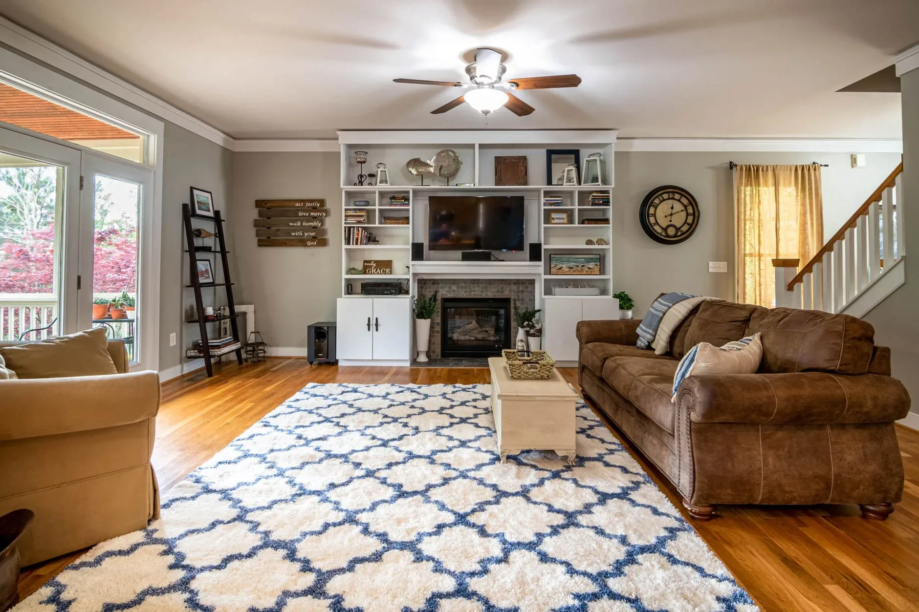15 High-End Living Room Ideas for Small Spaces Spacious living room featuring a ceiling fan, large sofa, and elegant decor for a modern yet cozy feel.