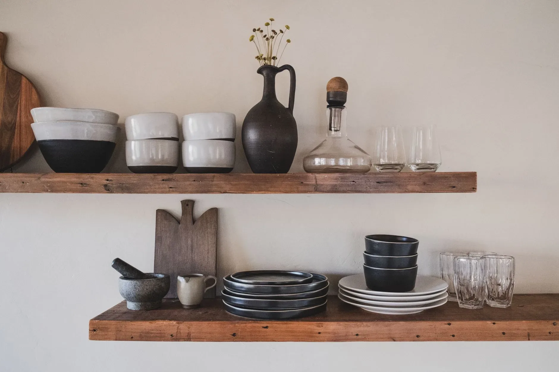 15 Wood Kitchen Ideas That Bring Warmth and Character to Any Home Stylish arrangement of ceramic bowls and glassware on rustic wooden shelves.
