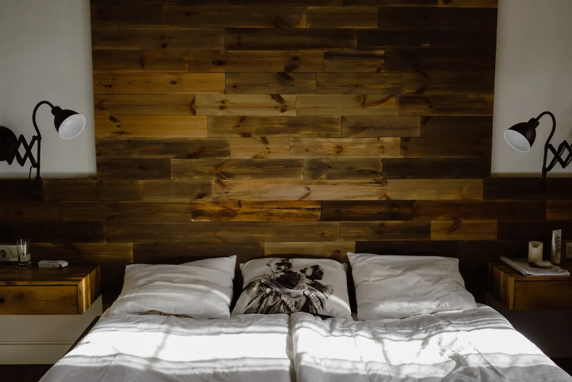 12 Wall Decor Ideas That Turn Every Blank Wall Into Something Beautiful Stylish bedroom interior featuring a wooden headboard and ambient lighting.