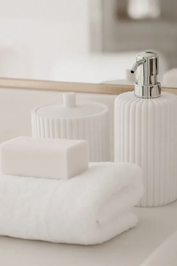 Stylish white soap bar and luxury towel arrangement in a modern bathroom setting.