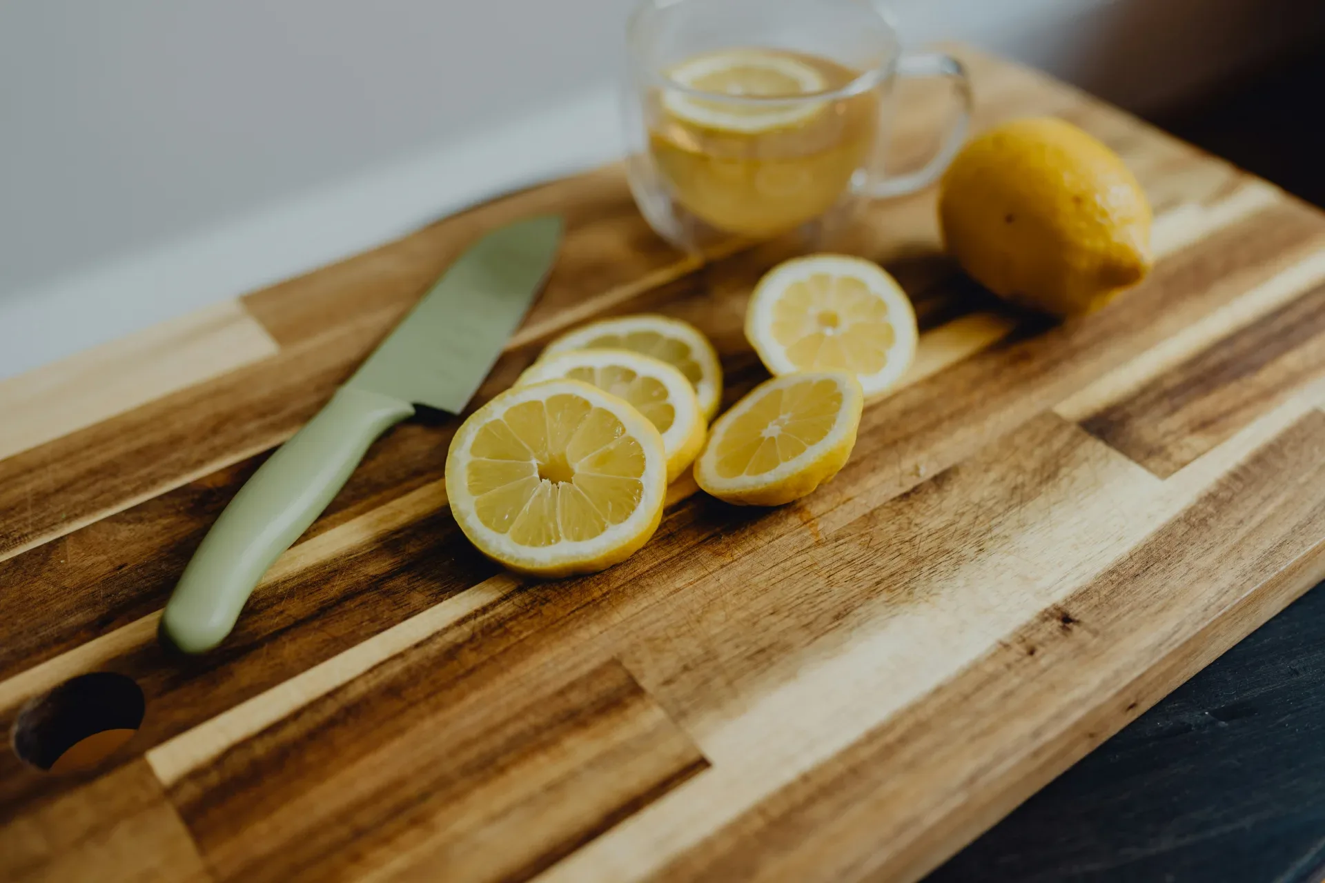18 Cozy Kitchen Decor Ideas for a Warm Home a cutting board topped with sliced lemons and a knife