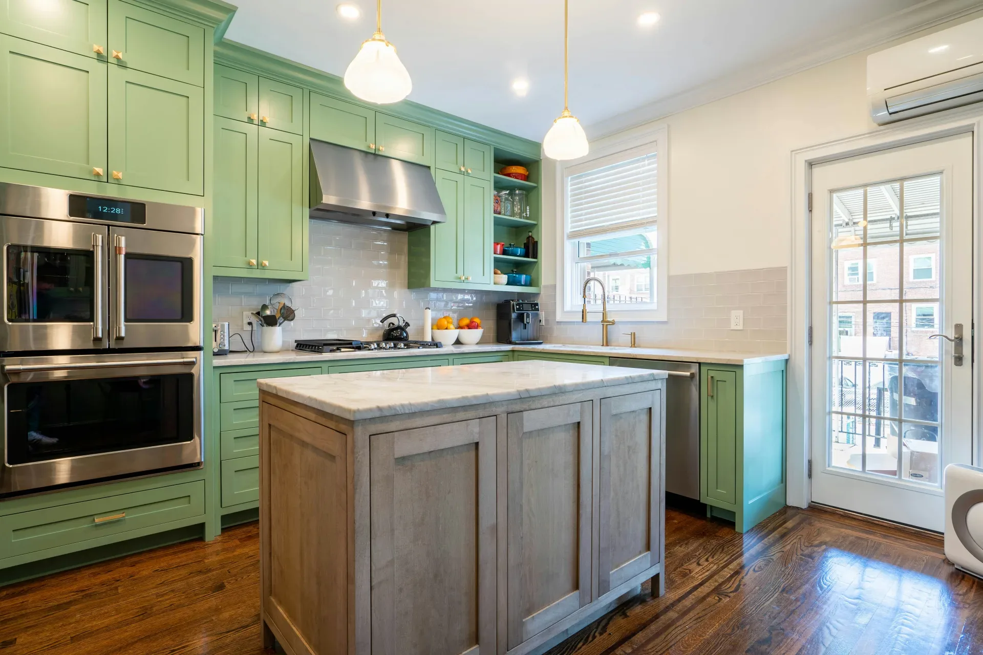 12 Green Kitchen Ideas That Feel Fresh and Modern a kitchen with green cabinets and stainless steel appliances